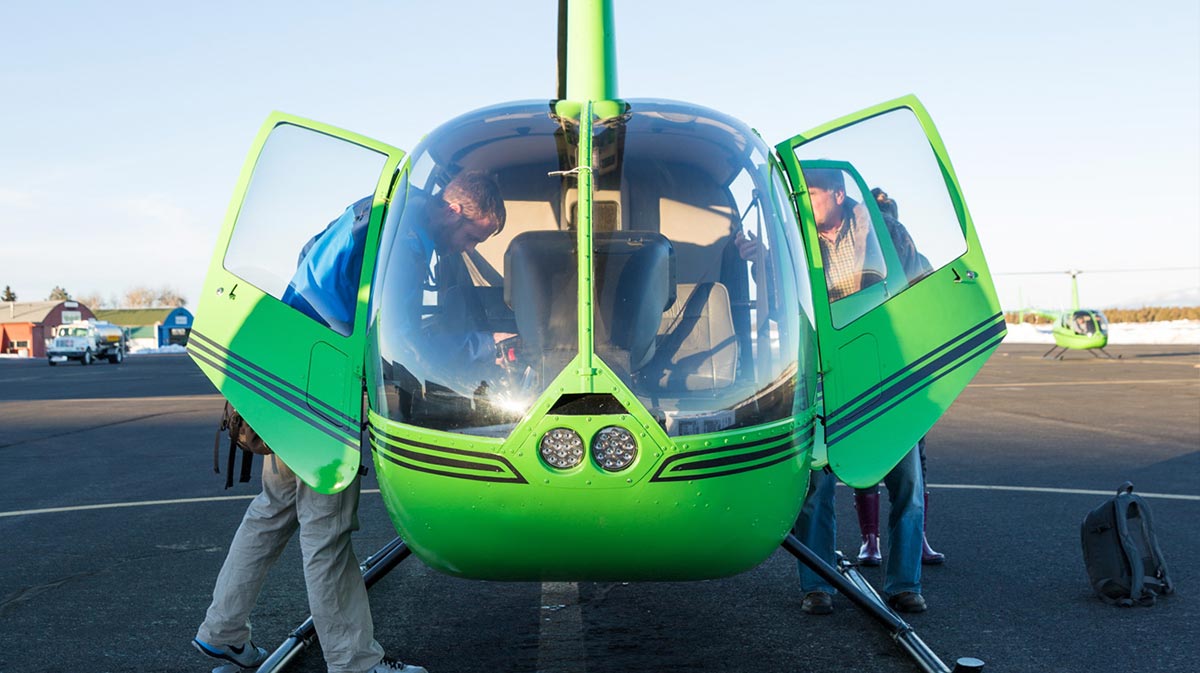 aviation schools, two students getting in helicopter