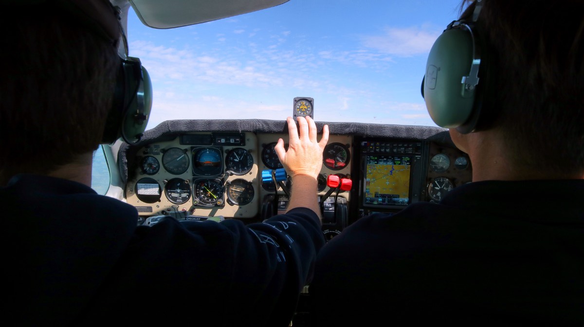 Two people piloting a flying helicopter for a blog about vfr lost procedures