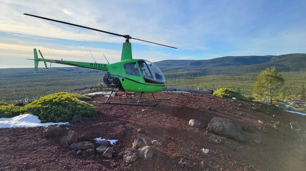 helicopter landing in field for a blog promoting instructor pilot course