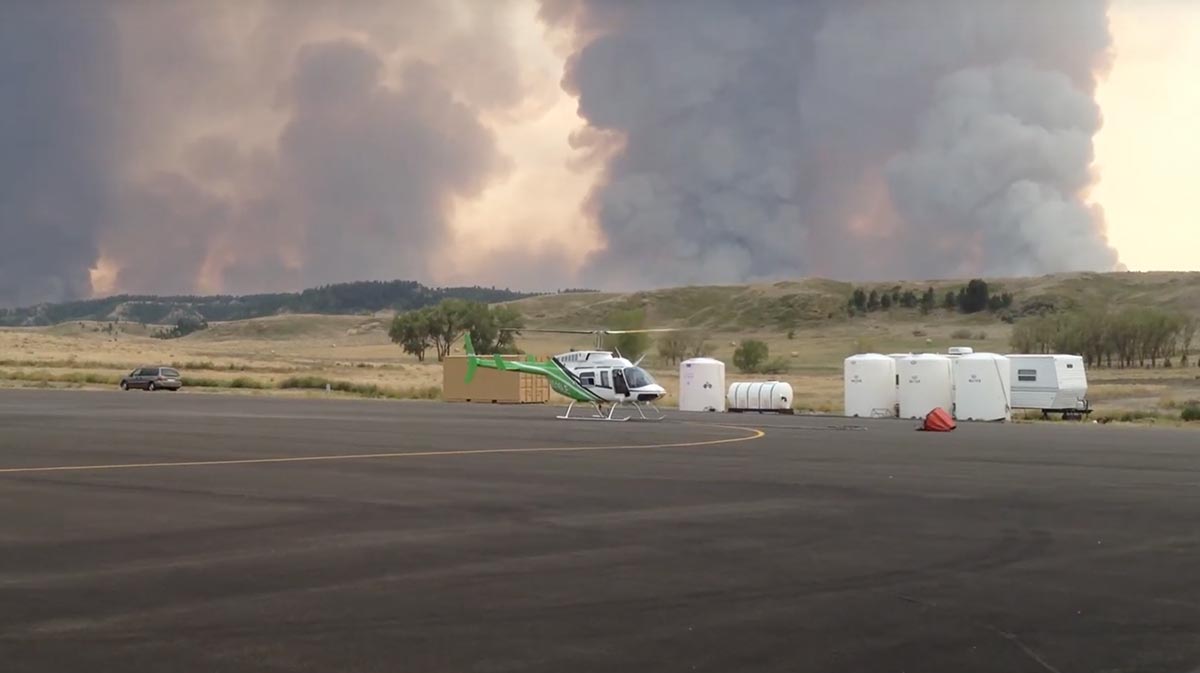 helicopter landing in front of smokey field for a blog about helicopter firefighter missions