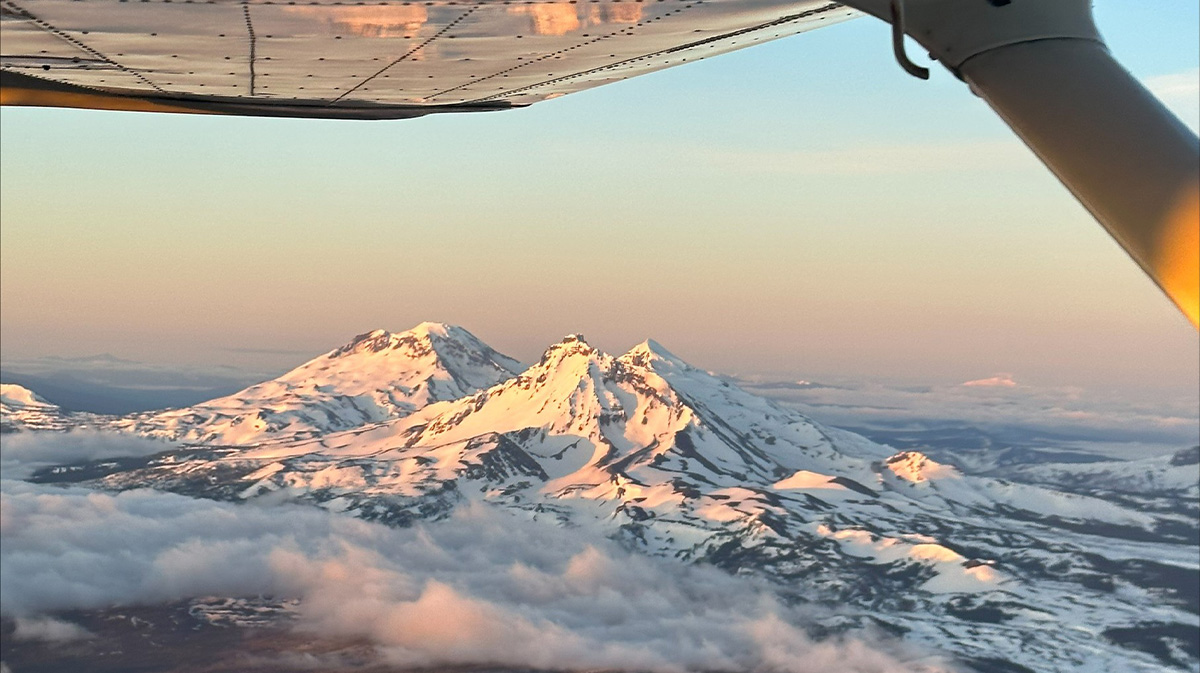 Snow capped mountains from pov of inside a helicopter, for a blog about the best flight schools in oregon